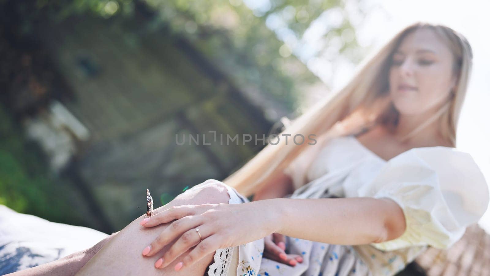 The girl gently enjoys the butterfly that flew to her