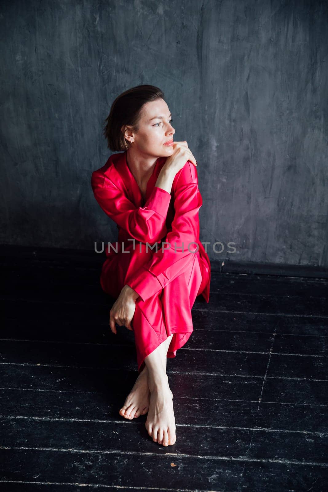 Beautiful woman in 40 years old in red silk pajamas