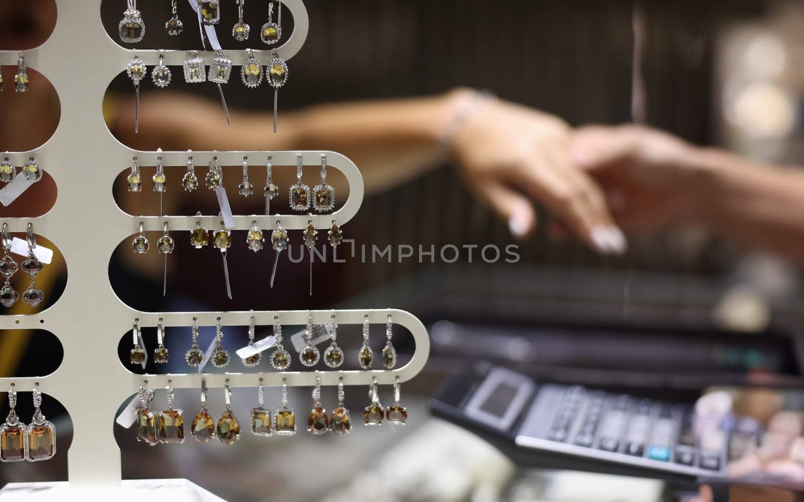 Lot of precious earrings with stones sold in jewelry store closeup by kuprevich
