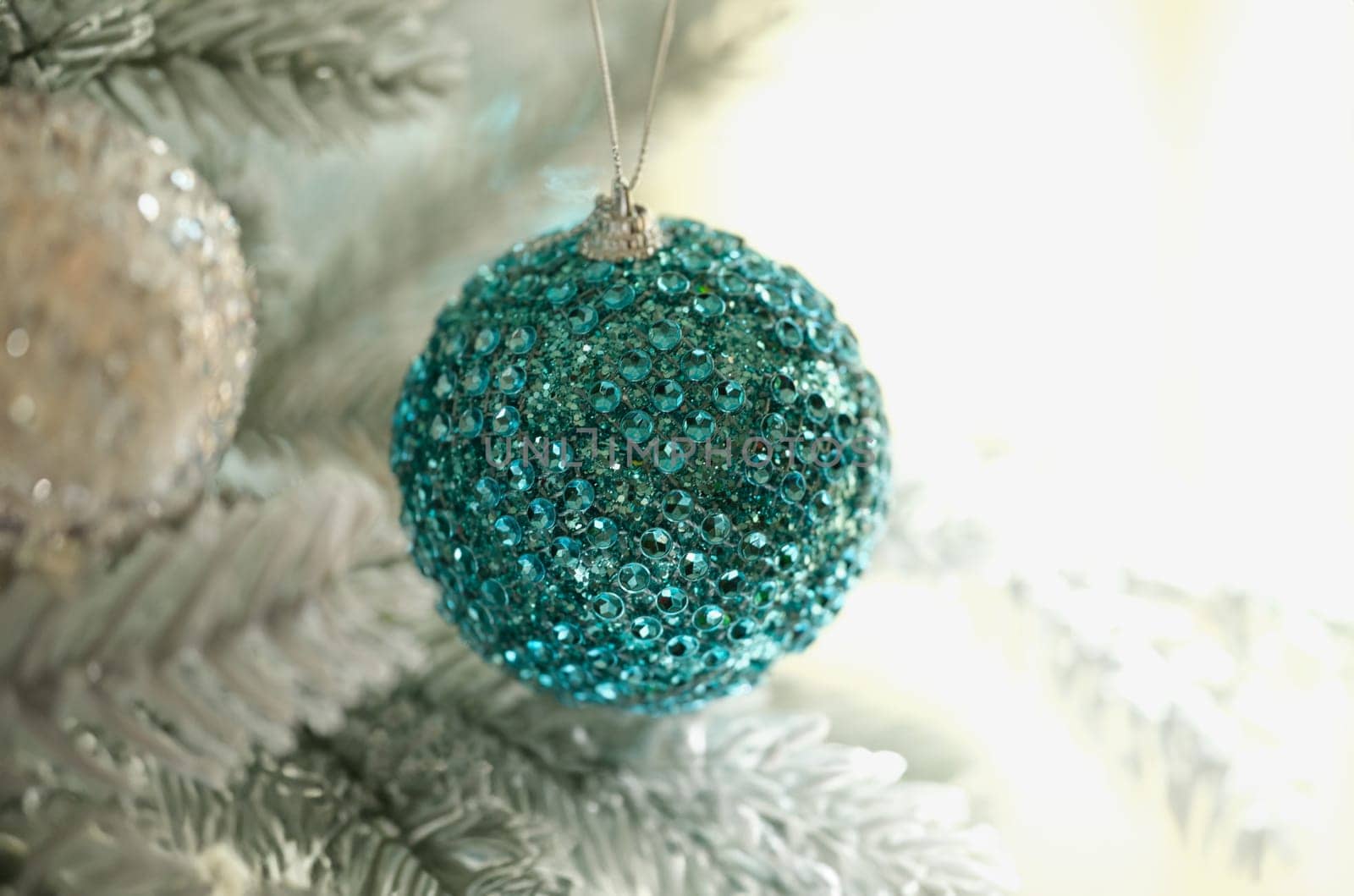 Bright blue christmas tree ball with shiny stones closeup. New Year decor concept