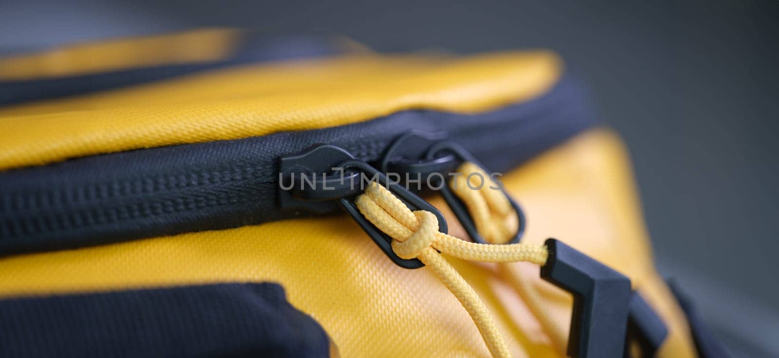 Zip lock with ropes on yellow backpack closeup by kuprevich