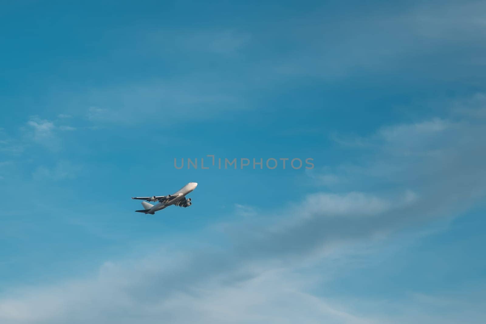 Airplane flies gaining altitude in blue sky in prescribed direction by apavlin