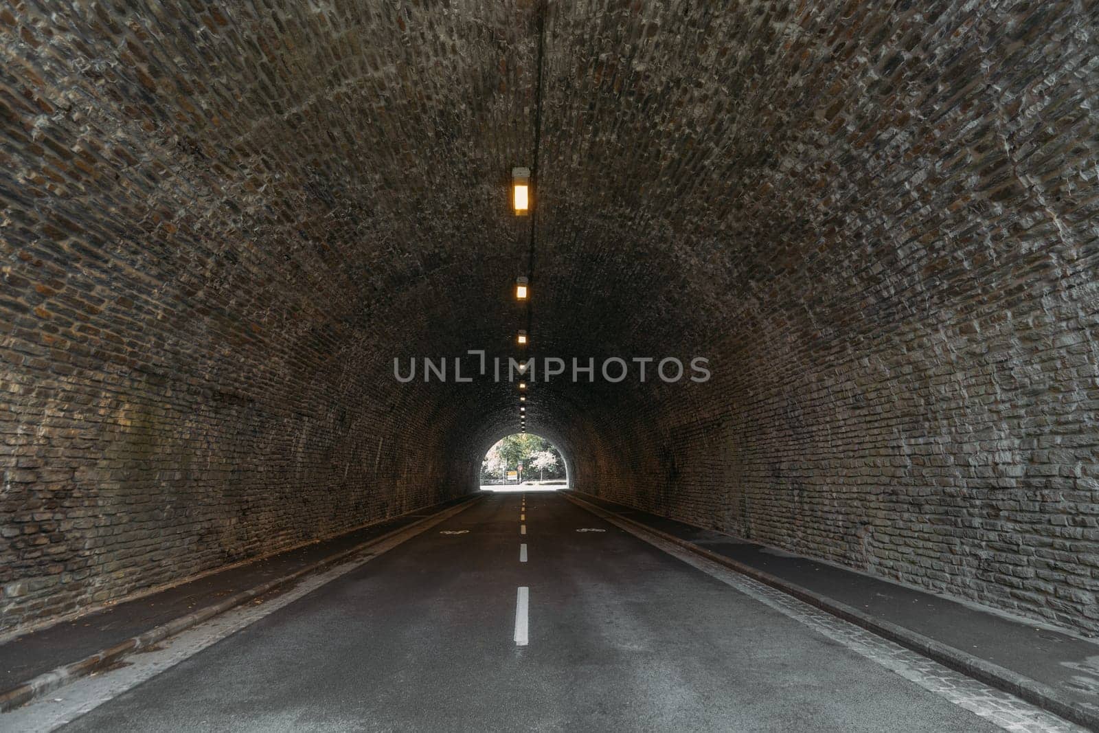 Infrastructure auto tunnel illuminated by lights at end by apavlin