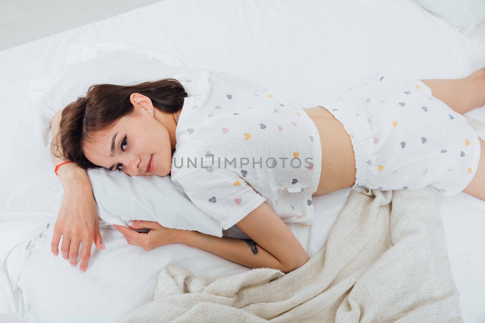 woman in pajamas sleeping in bedroom on bed
