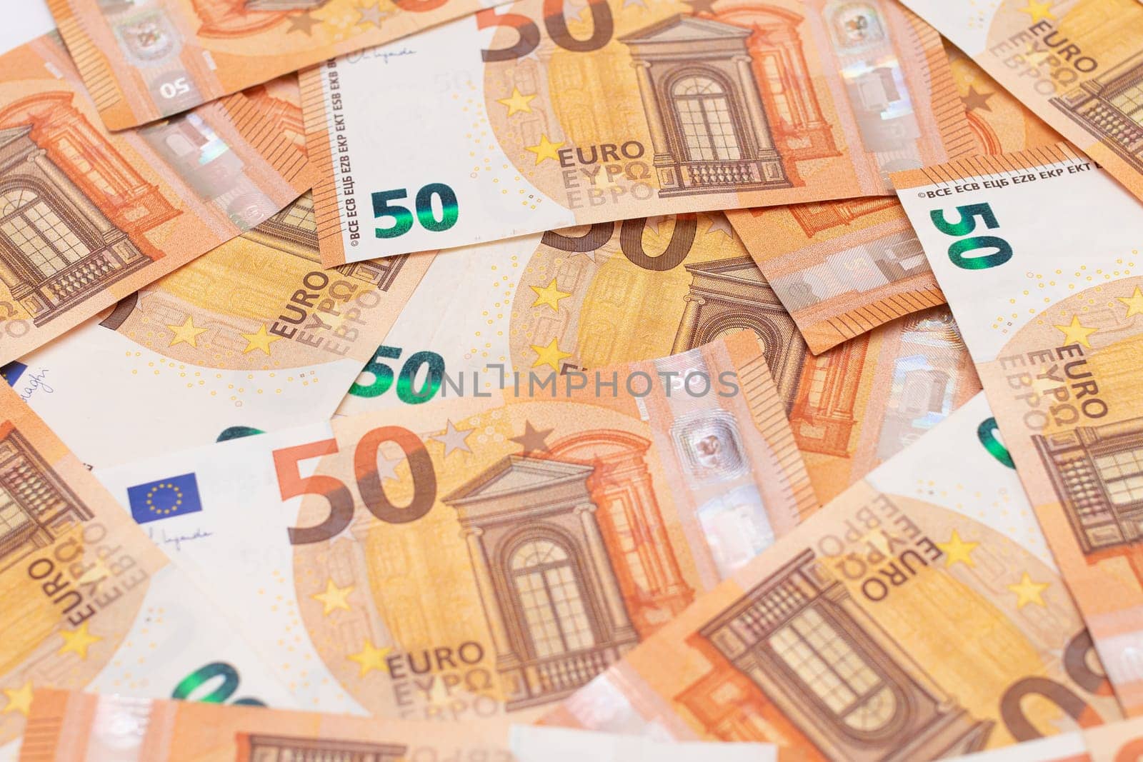 50 Euro Banknotes Money Background. Euro Money Currency. Orange Paper Money. A Lot of Fifty Euro Bills. Business, Finances, Cash and Money Saving Concept