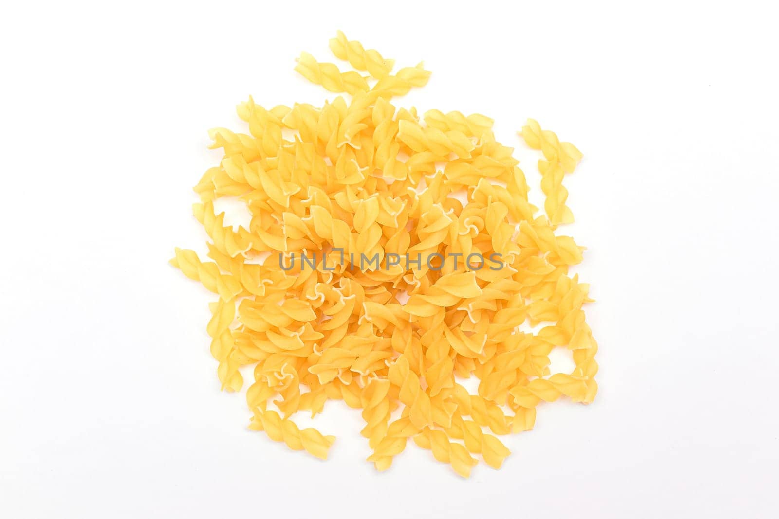 A Heap of Uncooked Fusilli Pasta Scattered on White Table by InfinitumProdux