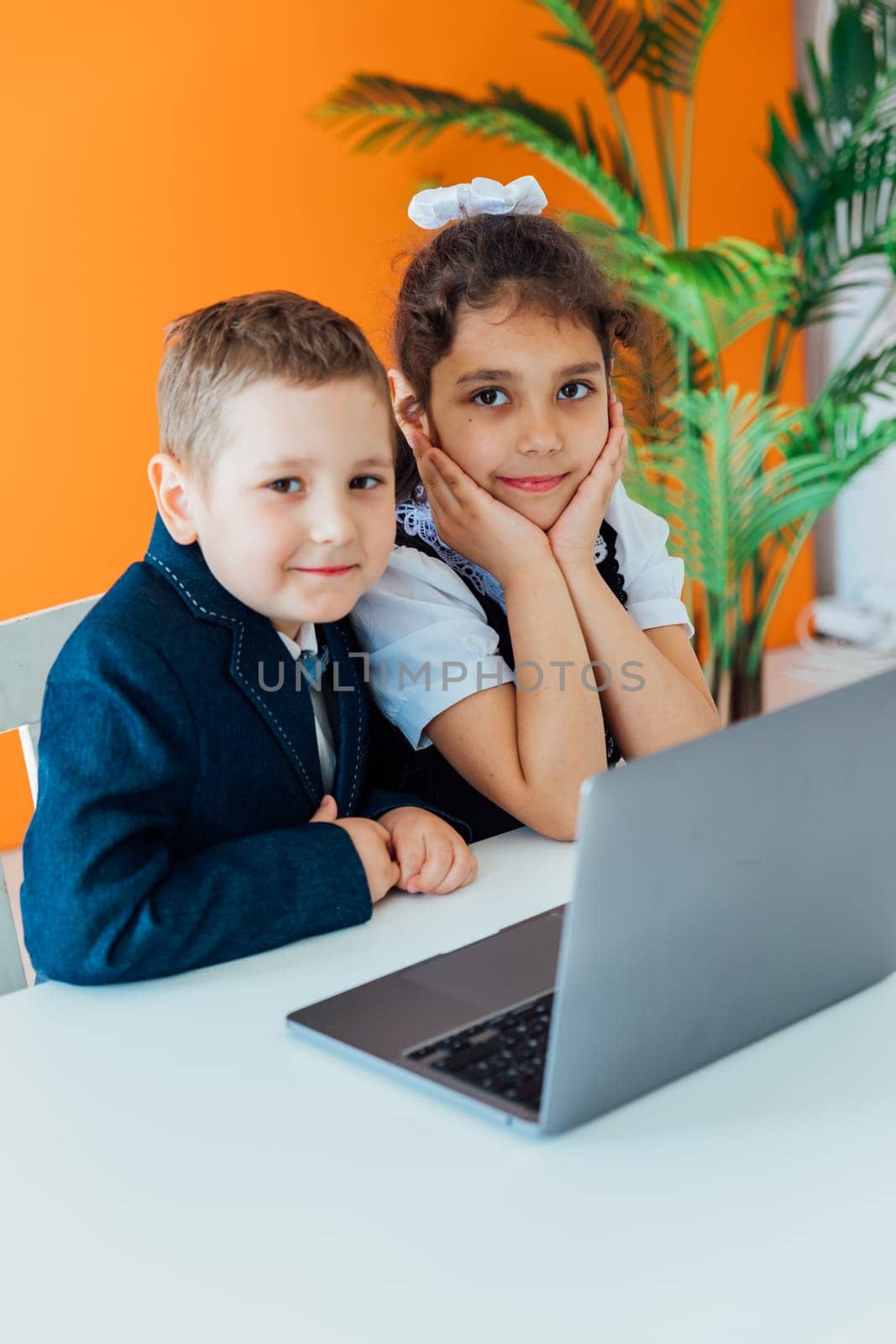 Boy and girl online learning watching laptop