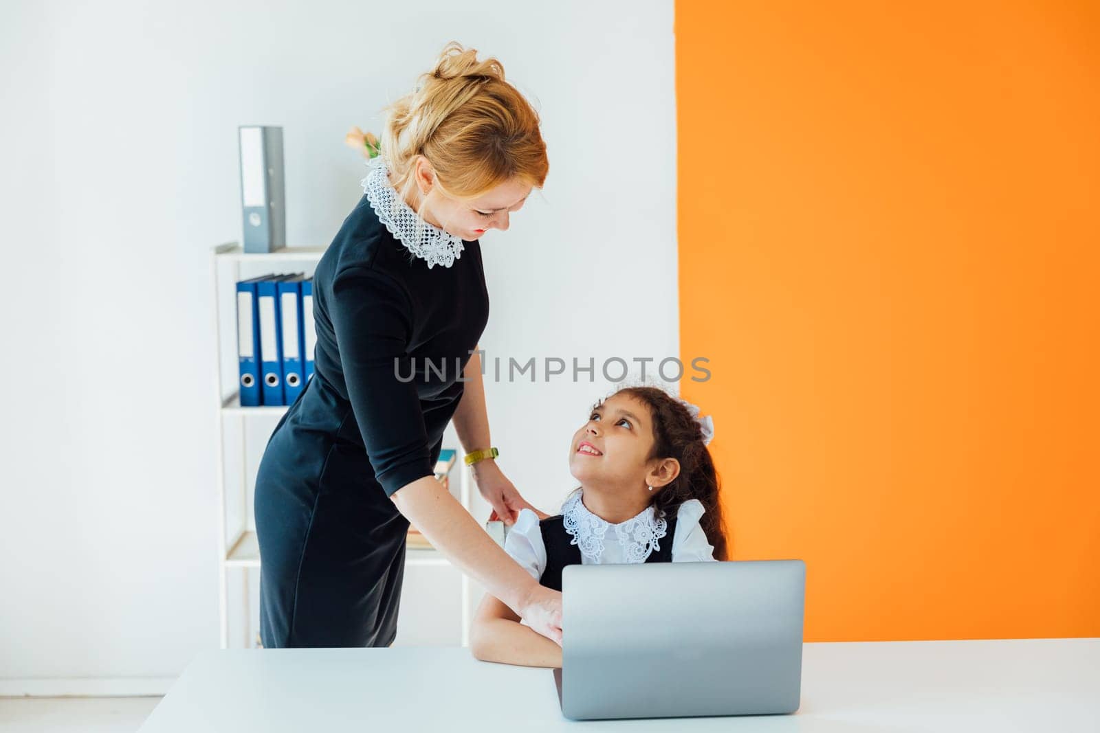 Female teaching kids to work on computer online