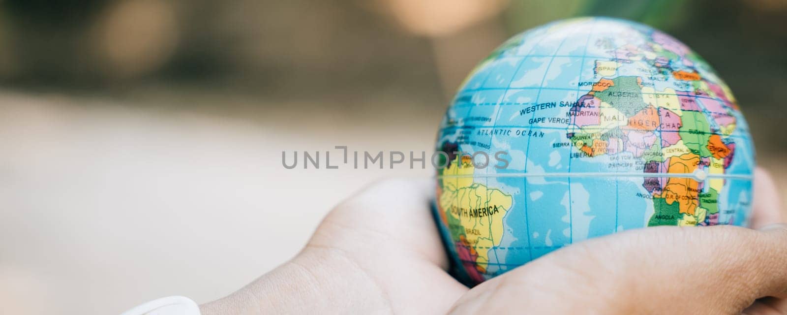 Embrace the Green Planet in your hands to signify Earth's preservation. This concept for Environment and Earth Day embodies responsibility, wisdom, and global support for our environment and nature. by Sorapop