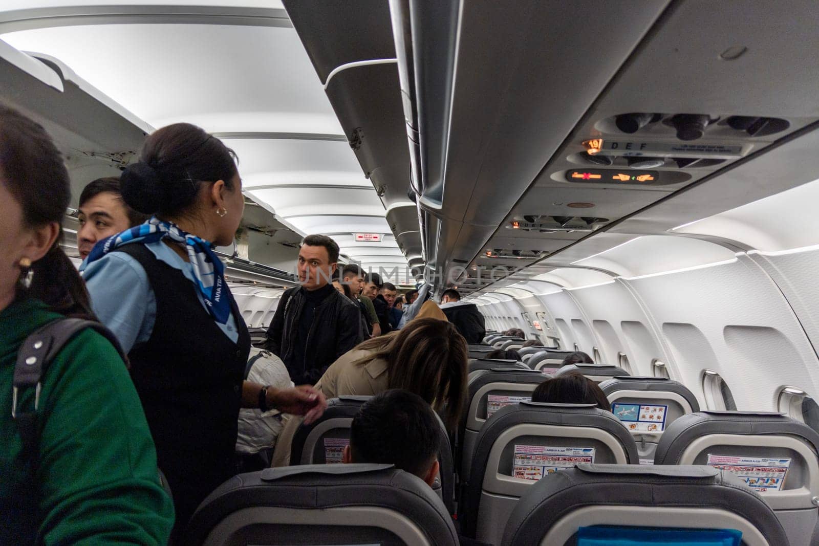 Inside of old Airbus A-320 while people are boarding by z1b