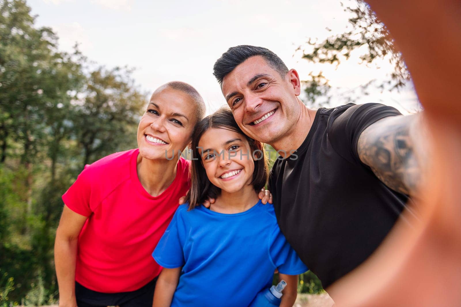 selfie photo of a happy sporty family in the nature, concept of outdoor activities with children and healthy lifestyle