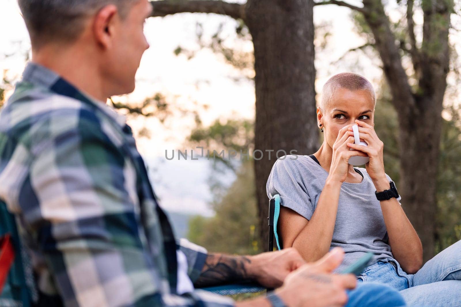 couple having coffee in the countryside, concept of active tourism in nature and outdoor activities