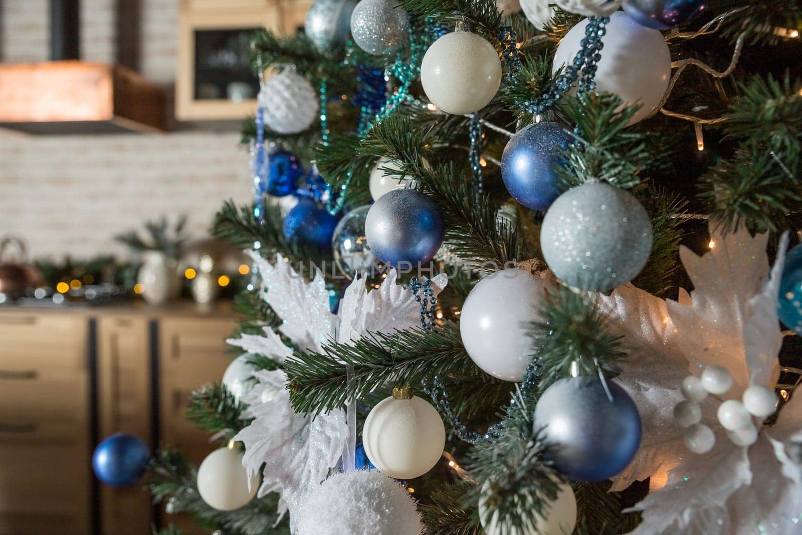 Christmas tree with blue and white toys in the interior.Christmas card