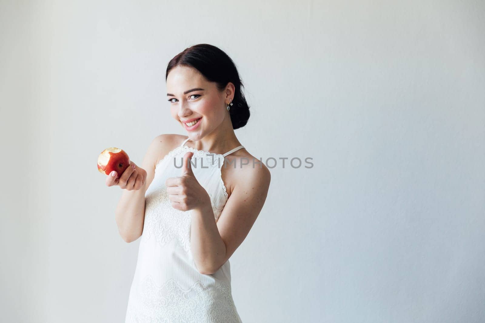 Beautiful fashionable brunette woman and ripe apple for eating