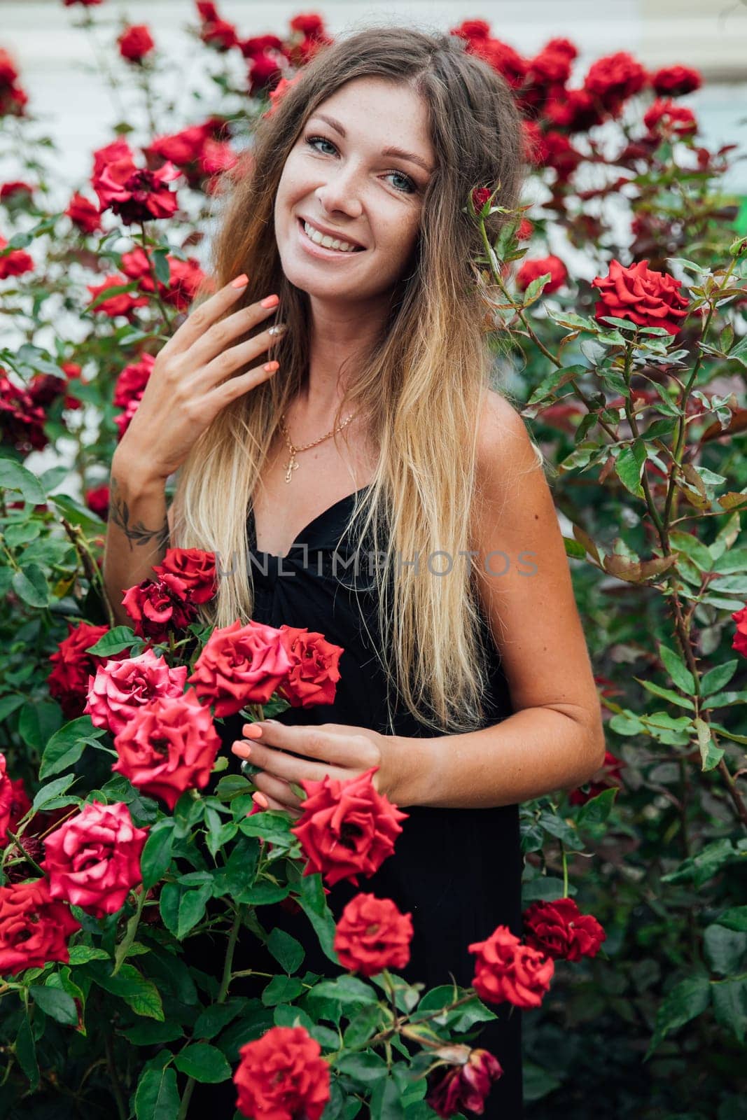 Portrait of a beautiful young woman with flowers outdoors by Simakov