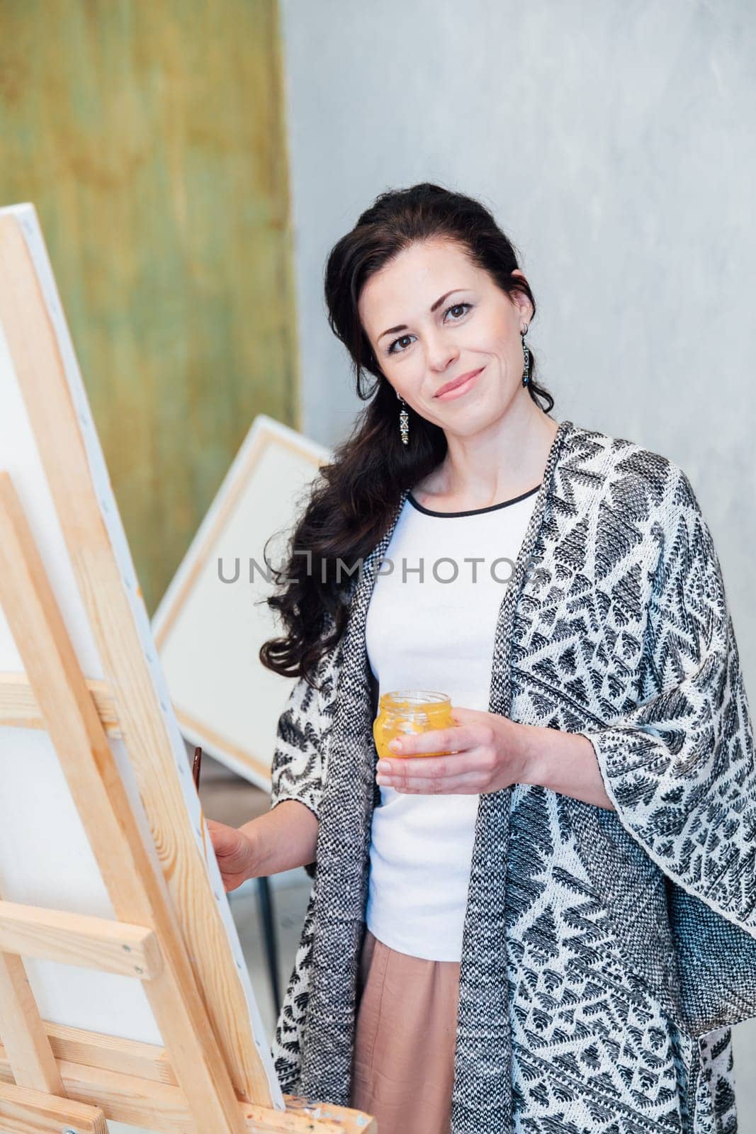 Female Artist Works on Abstract Oil Painting, Moving Paint Brush Energetically She Creates Modern Masterpiece. by Simakov