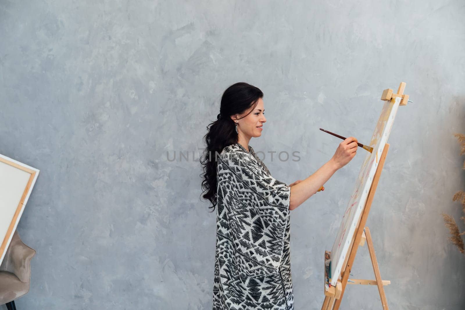 Female Artist Works on Abstract Oil Painting, Moving Paint Brush Energetically She Creates Modern Masterpiece. by Simakov