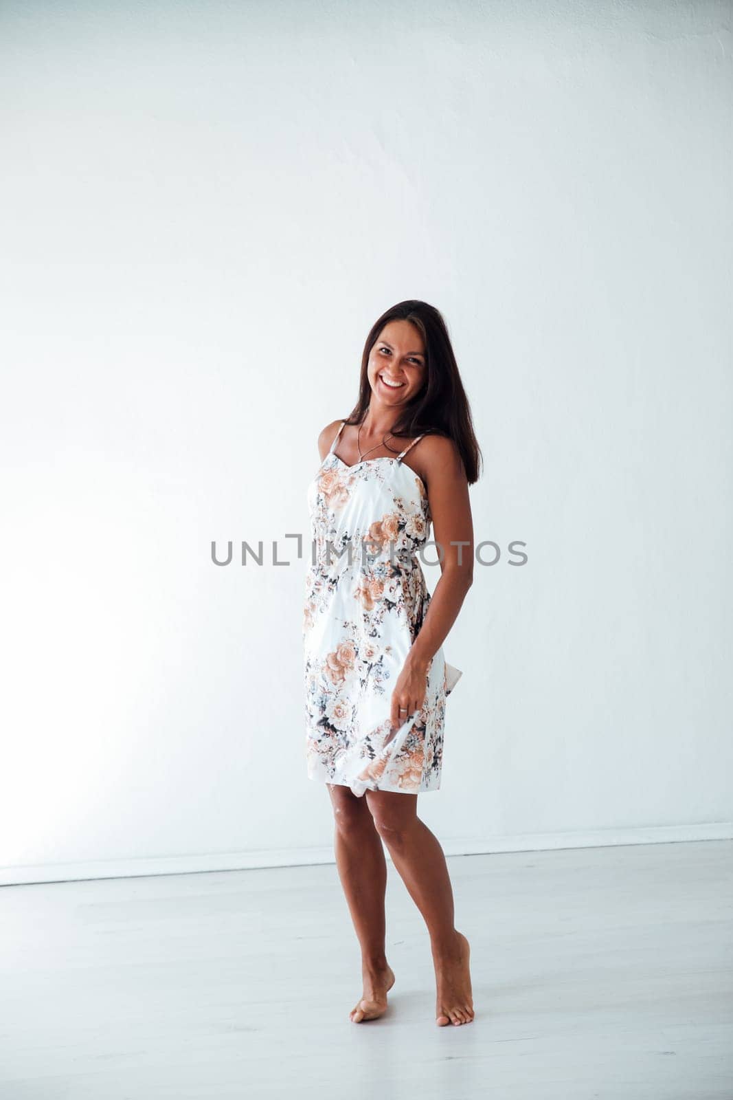 tanned woman in summer dress on white background