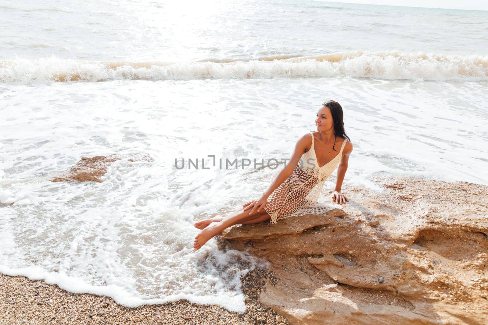 tanned woman bathing on the beach in the sea