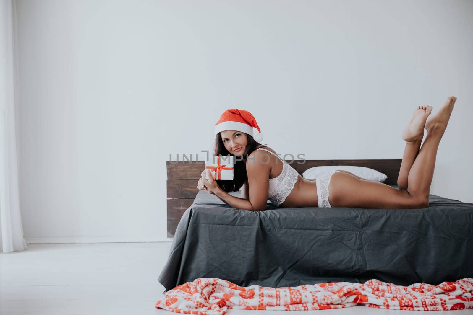 woman in bedroom on bed christmas year gifts