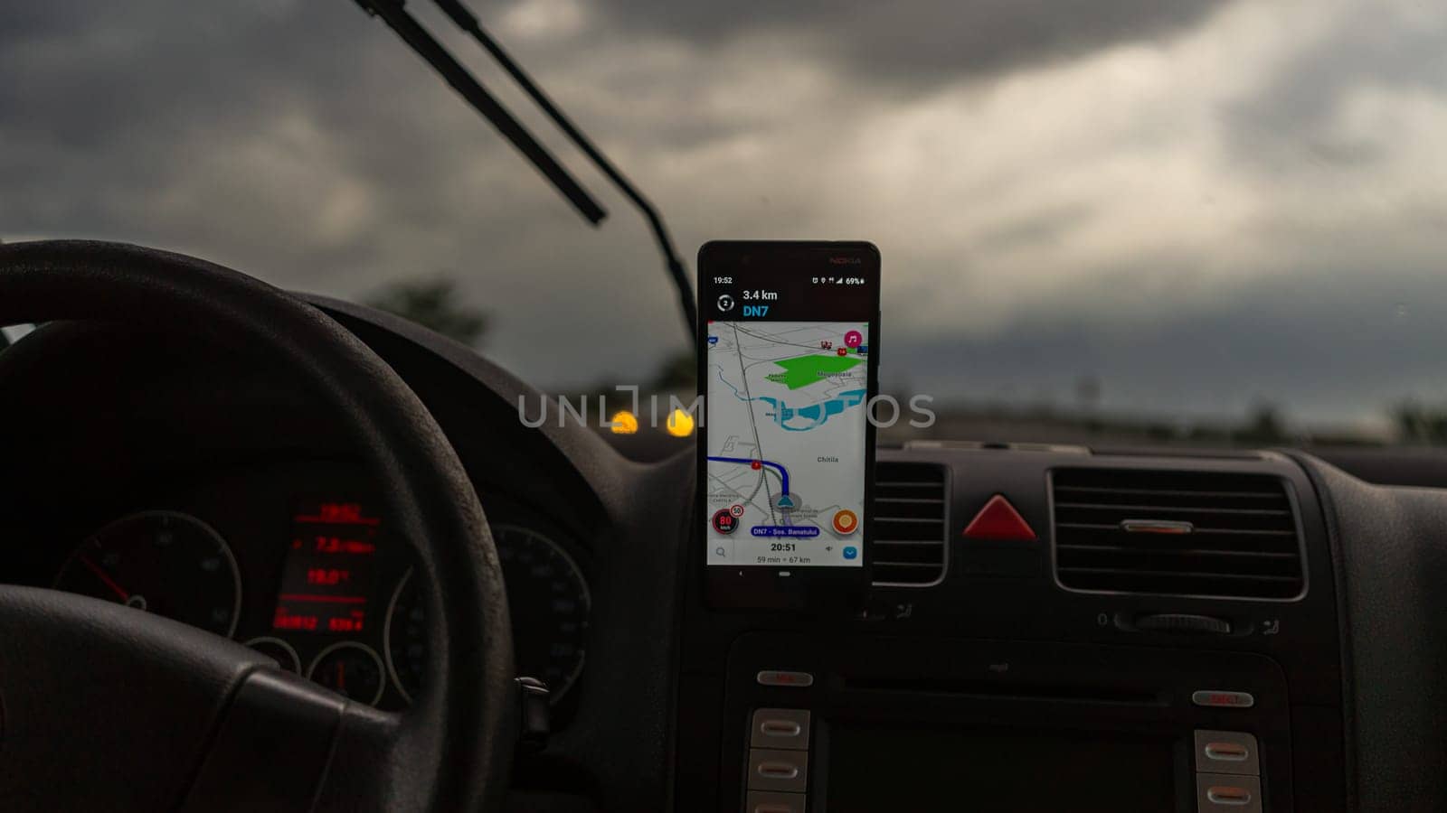 Smartphone showing Waze maps to show the way thru the city by vladispas