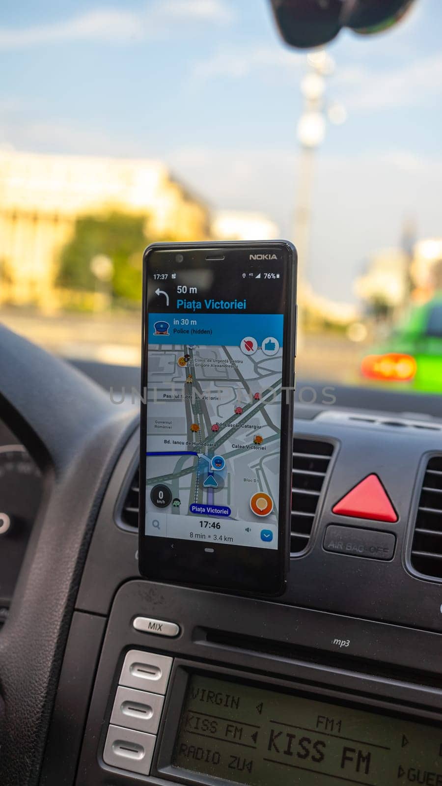 Smartphone showing Waze maps to show the way thru the city by vladispas