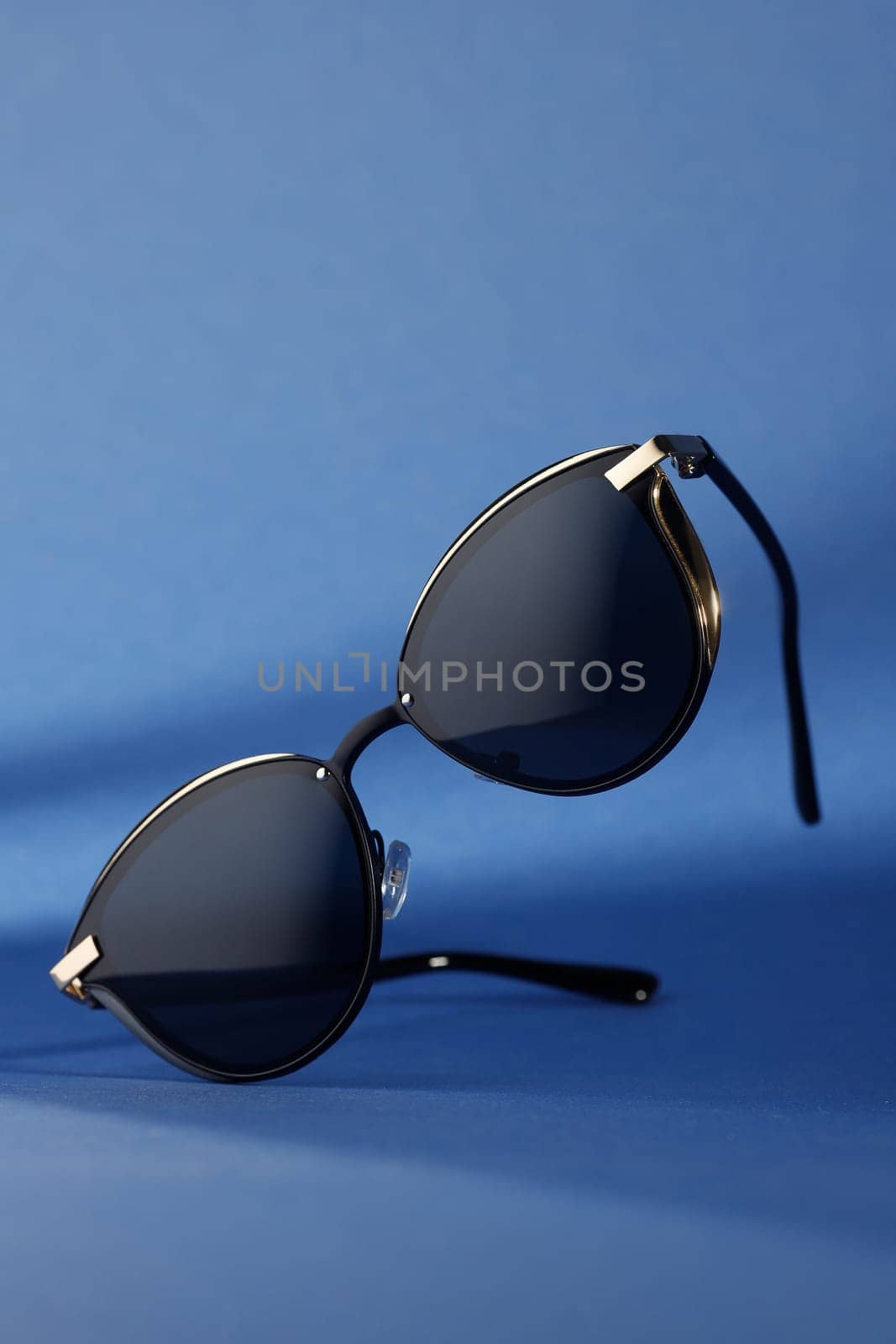 stylish women's sunglasses isolated on color paper background