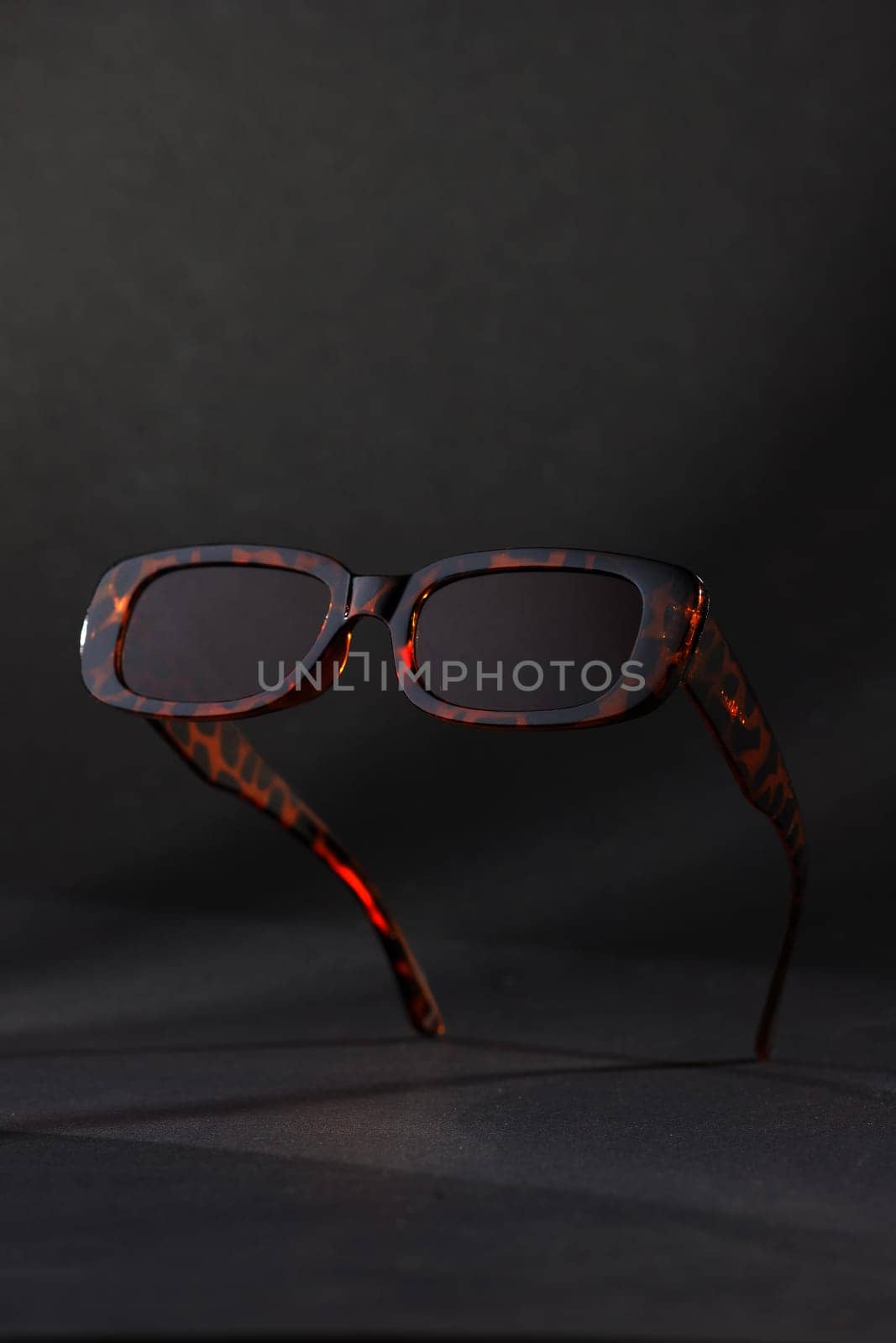 Trendy sunglasses background. Fashion summer accessories. Copy space for text. Red snake concept. Optic store discount poster by Gravika