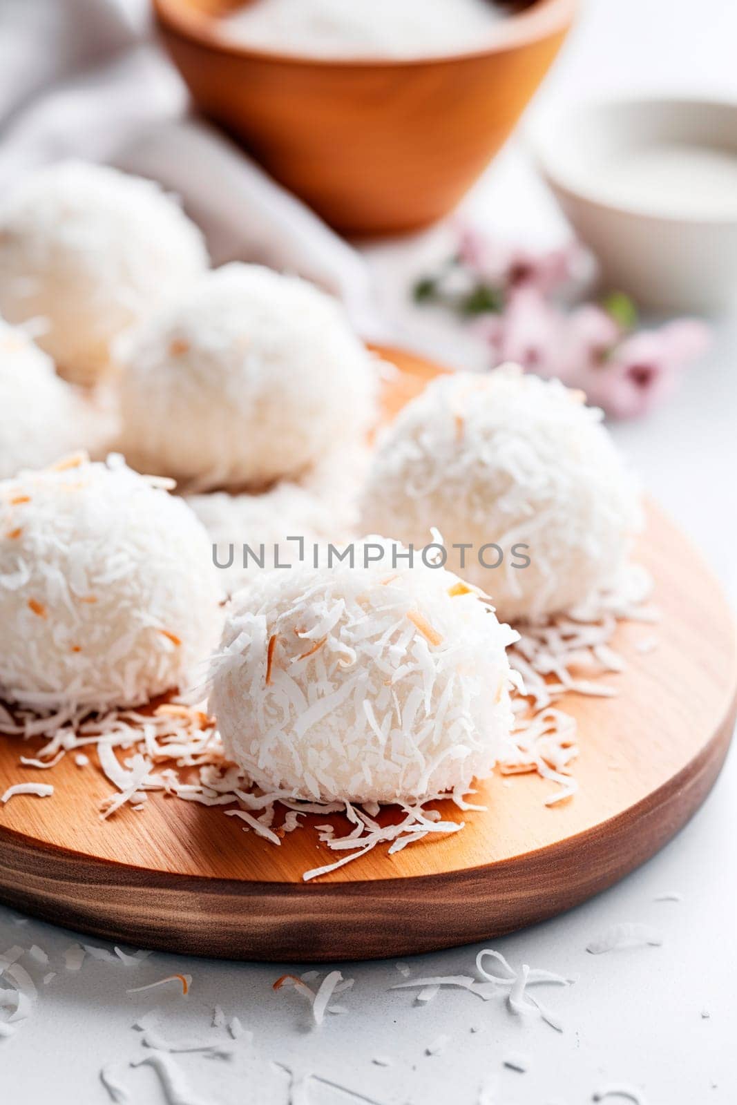 Coconut balls dessert with coconut flakes. Generative AI, by yanadjana