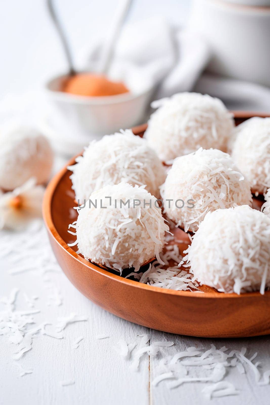 Coconut balls dessert with coconut flakes. Generative AI, by yanadjana