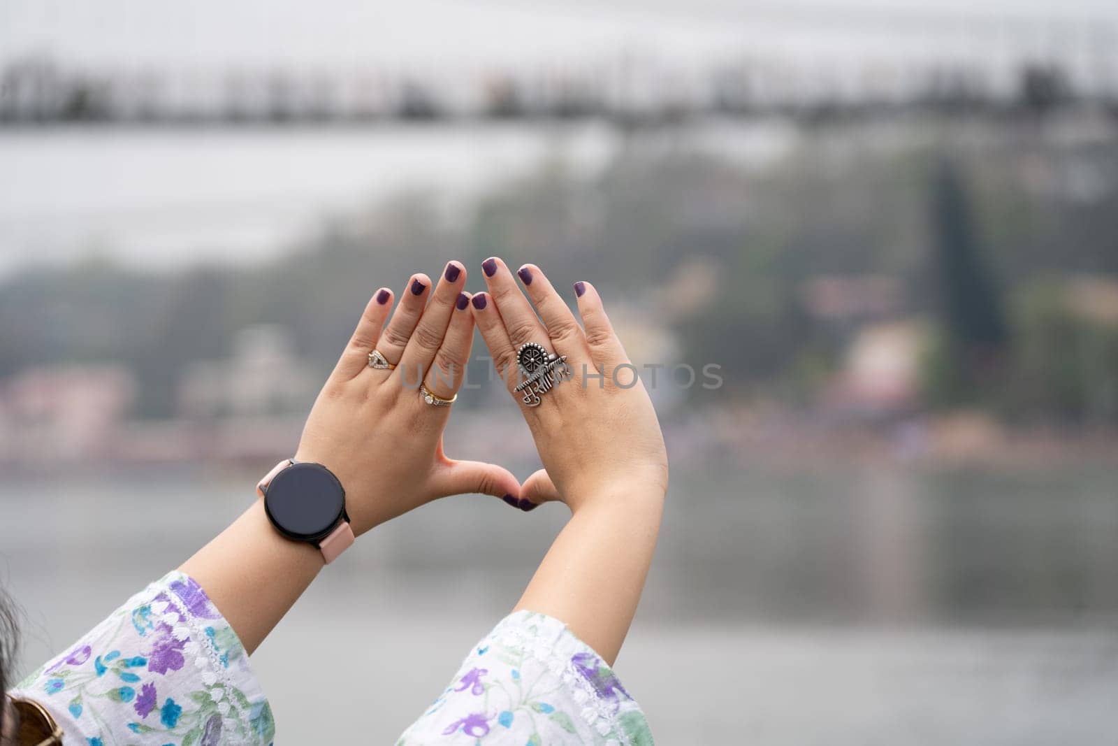 Hands of indian woman with purple nail polish and ring saying musafir meaning traveller in Hindi showing the trend of travelling by Shalinimathur