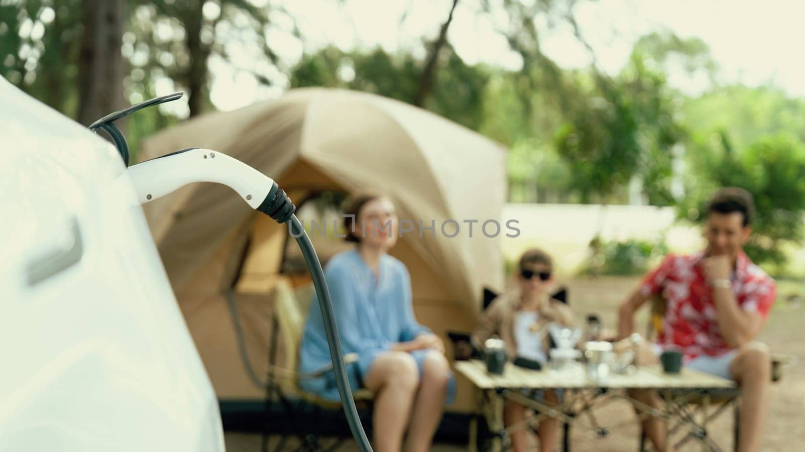 Lovely sit on trunk, charging EV car with EV charging station. Perpetual by biancoblue