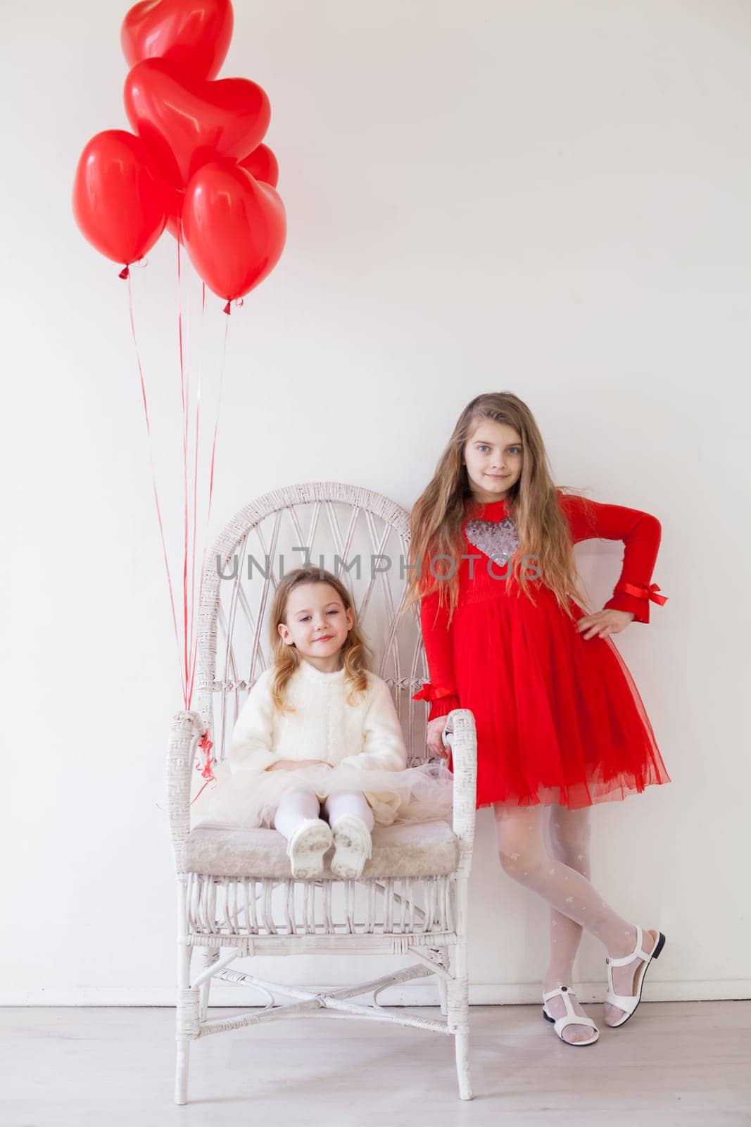 Little girl with red balloons for the holiday