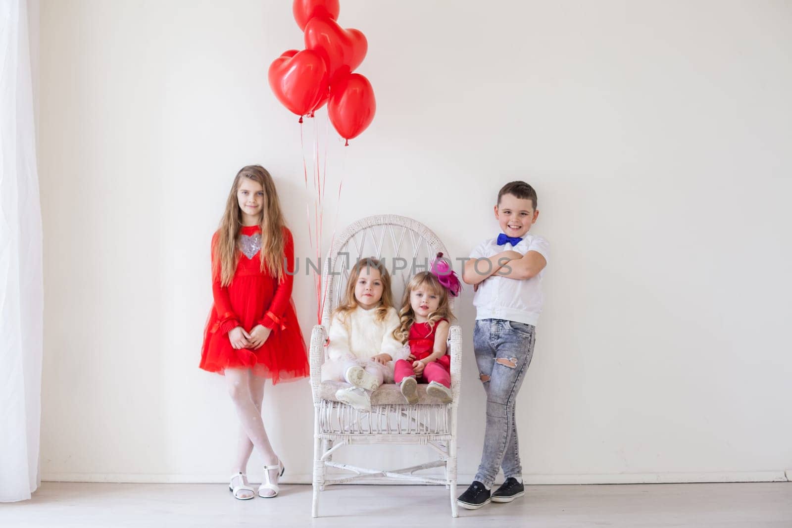Kids friends boy and girl with red balloons on holiday by Simakov