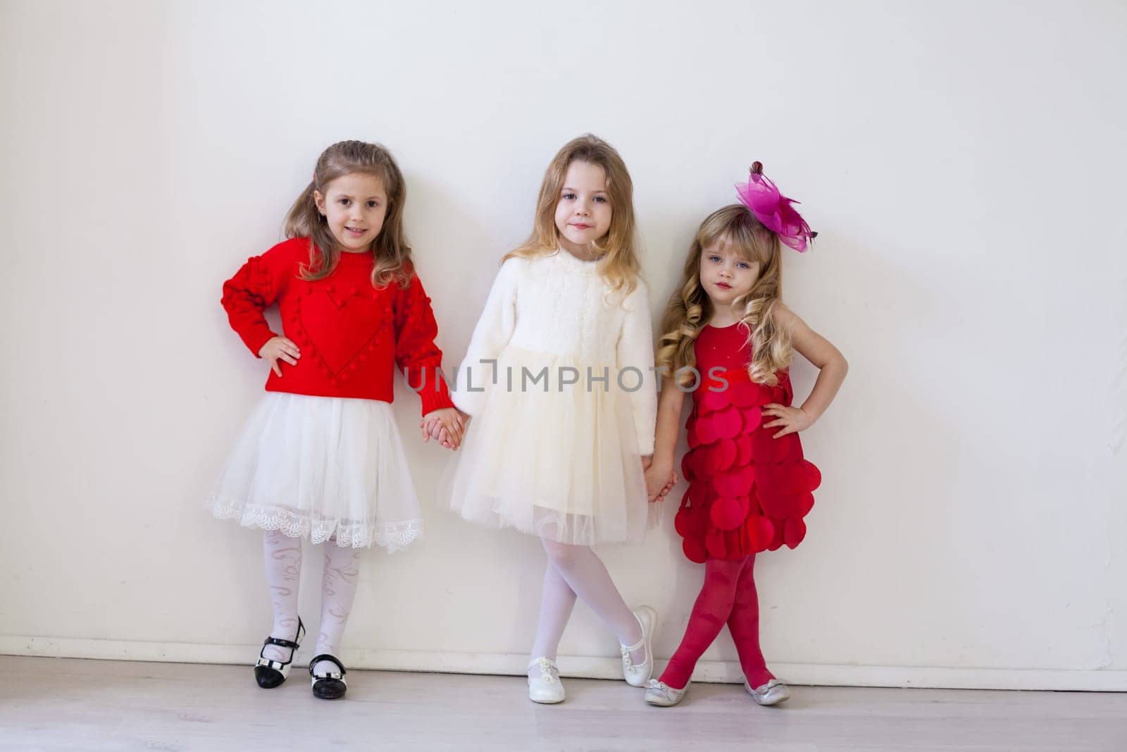 kids are friends of different ages together in a white room by Simakov