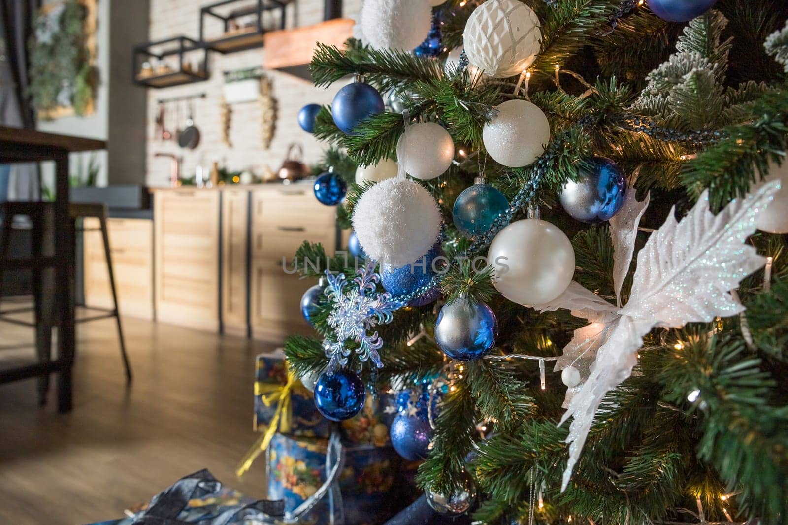 Christmas tree with blue and white toys in the interior,