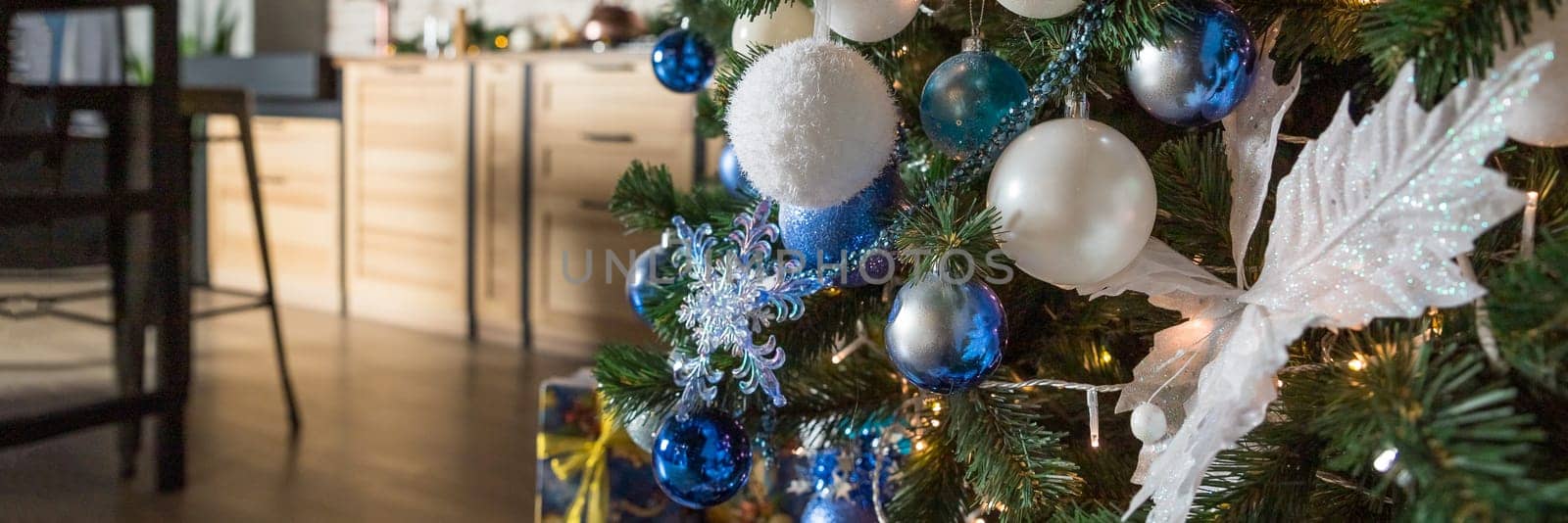Christmas tree with blue and white toys in the interior,