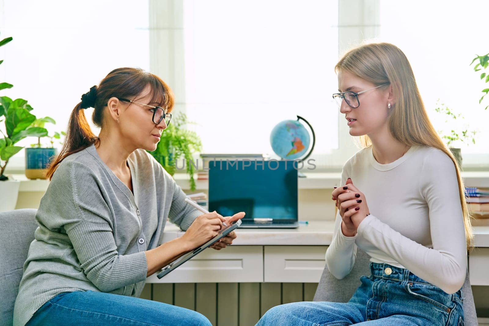 Young teenage girl talking with psychologist, therapist by VH-studio