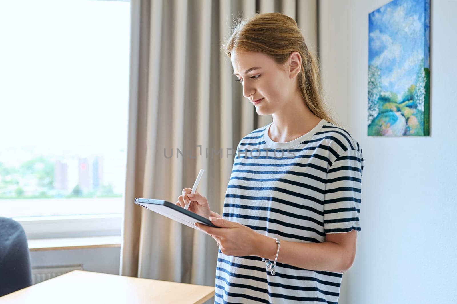 Portrait of teenage girl using digital tablet at home by VH-studio