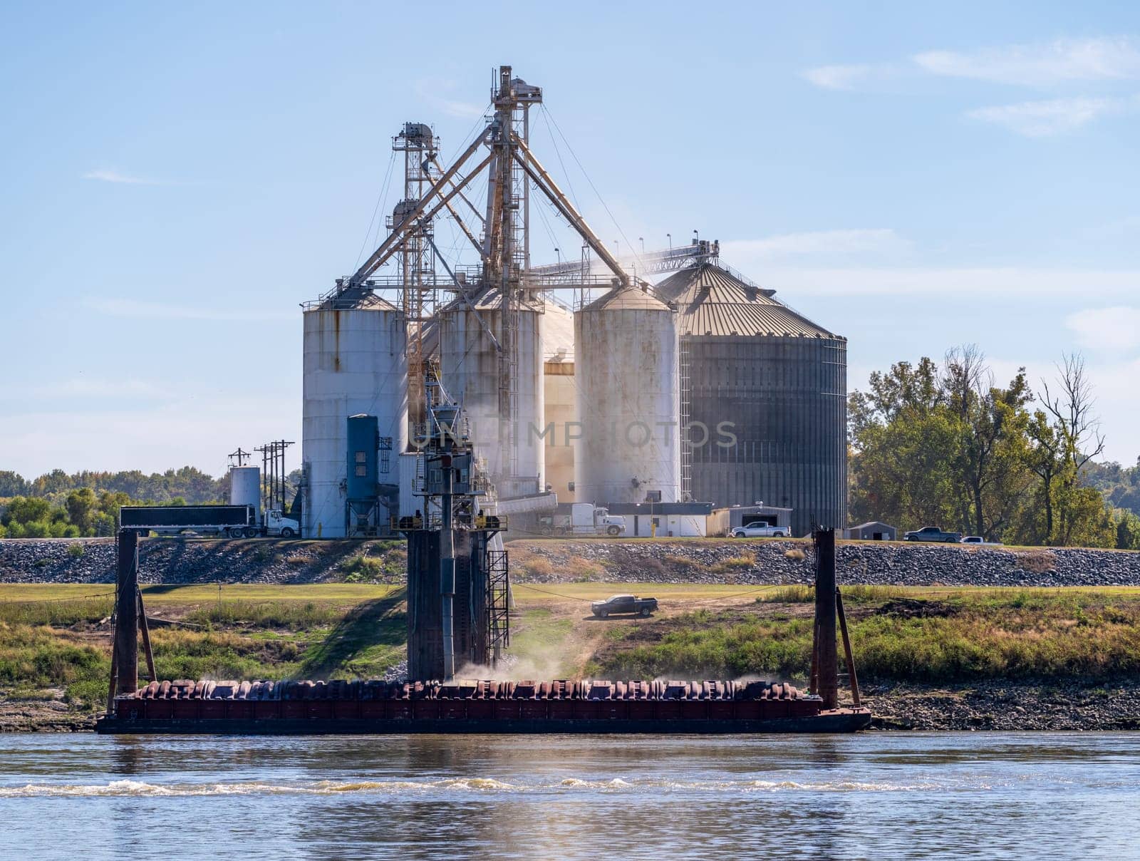 Grain being loaded into freight barges on lower Mississippi river by steheap