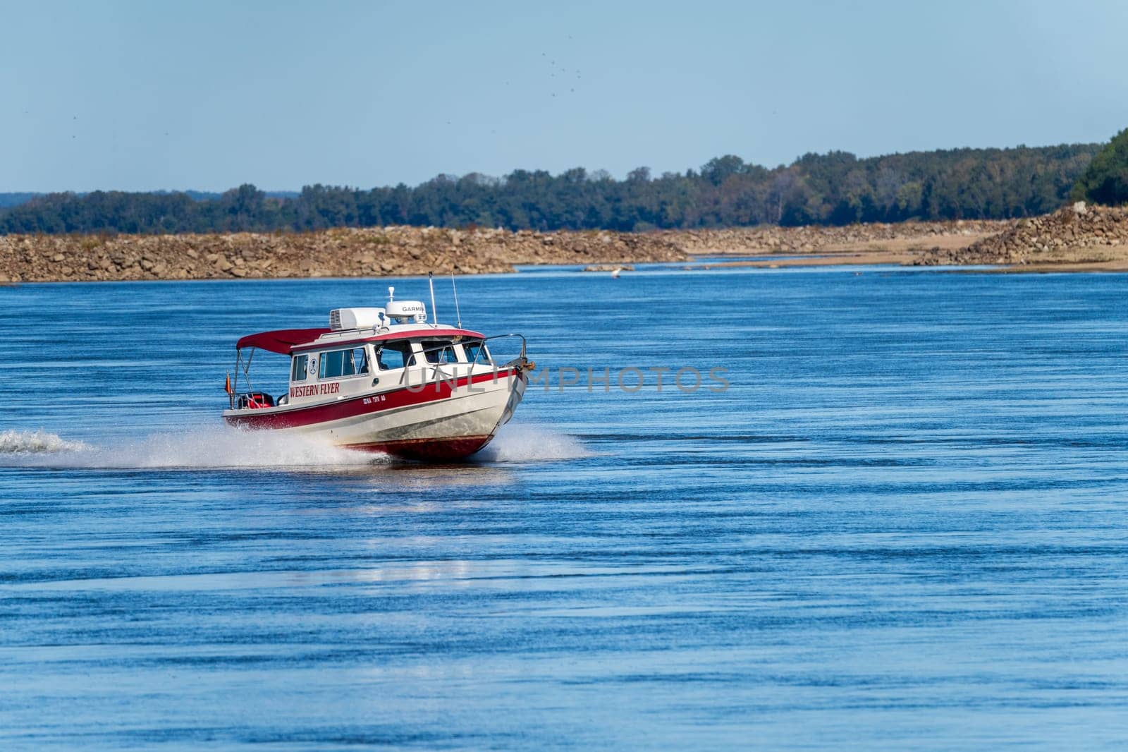 Cairo, IL - 22 October 2023: Small speeding boat coming down the Mississippi river near Cairo in Illinois