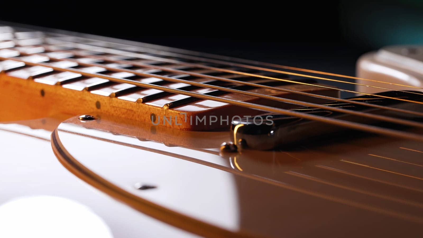 Macro of strings on electric guitar fretboard. Details of instrument close-up. Music, sound, art background. High quality