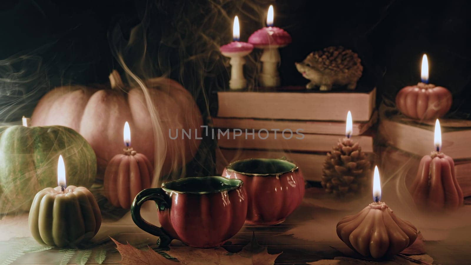 Cute cups of tea among pumpkin candles. Autumn-themed content, cafe promotions by kristina_kokhanova