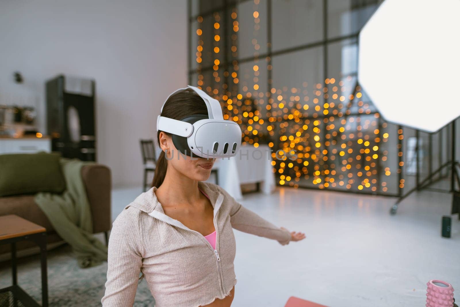 A personal trainer conducts virtual fitness sessions at home through a virtual reality headset during the Christmas festivities. High quality photo