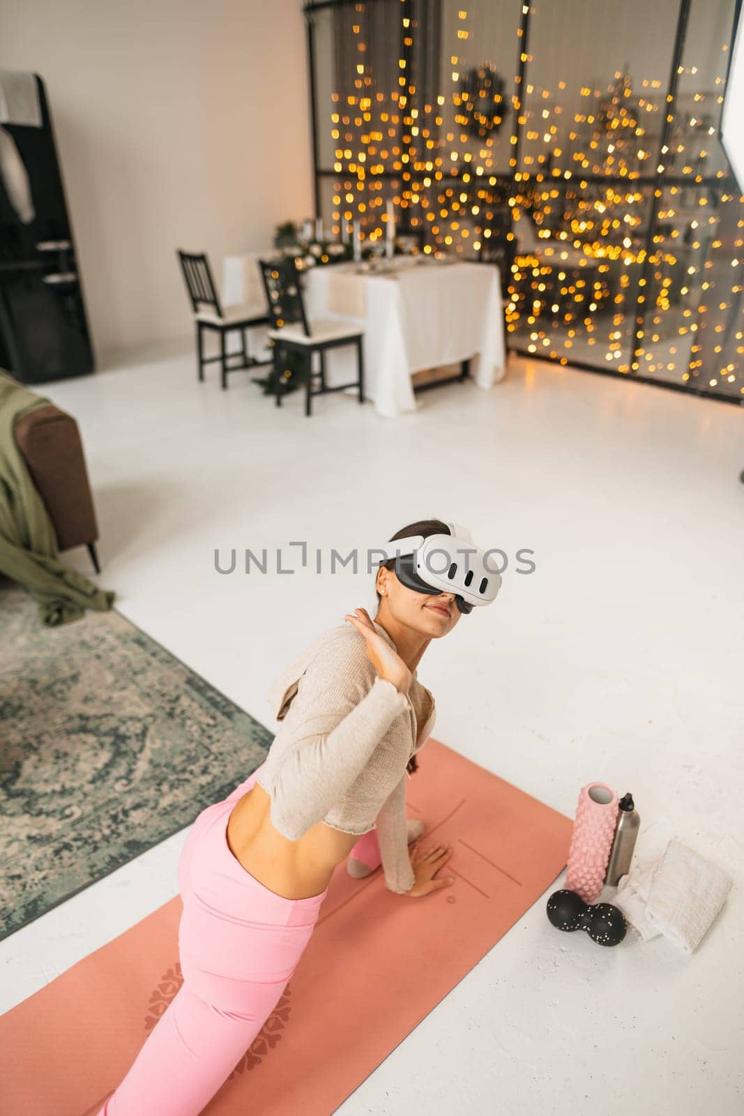 Stretching exercises for the arms during at-home workouts with a virtual reality headset amidst the Christmas celebrations. High quality photo
