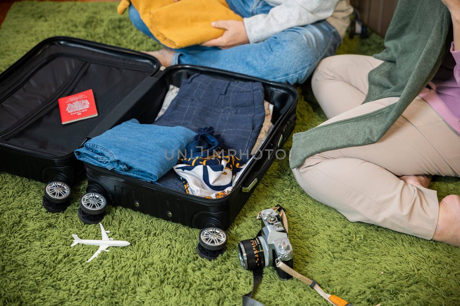 Asian couple old senior marry retired couple prepare luggage suitcase arranging for travel, Romantic retired packing clothes travel bag suitcase together on floor at home interior living room