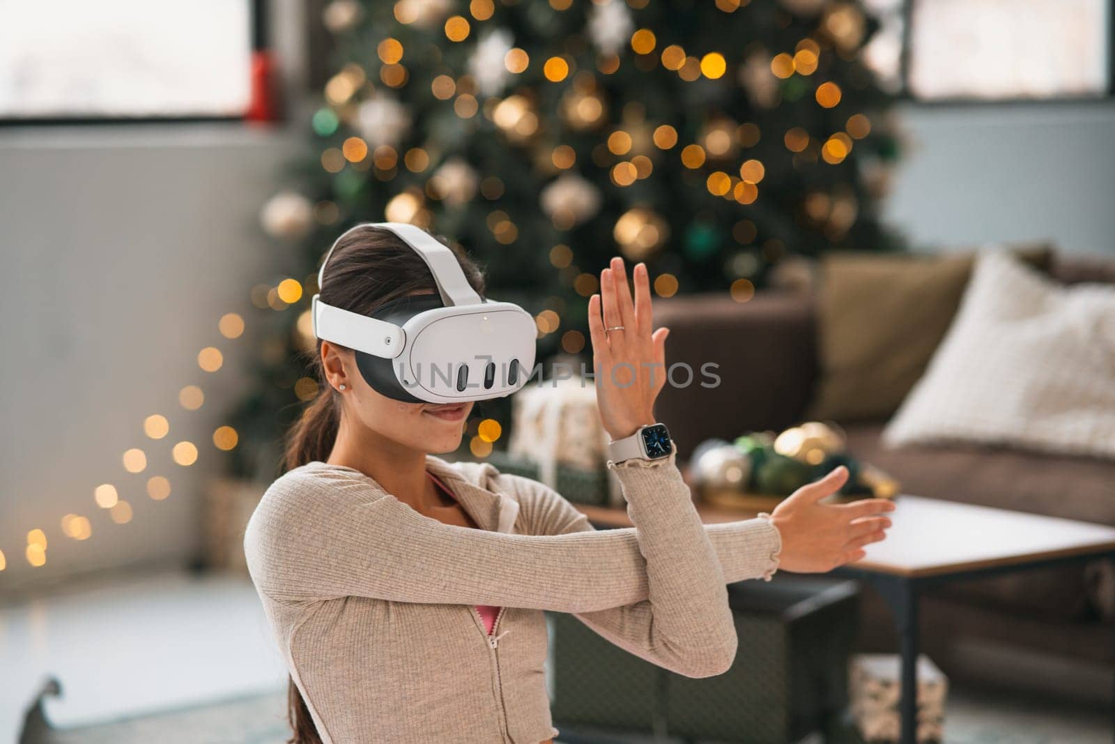 A sporty and beautiful girl doing her stretches while wearing a virtual reality headset. by teksomolika