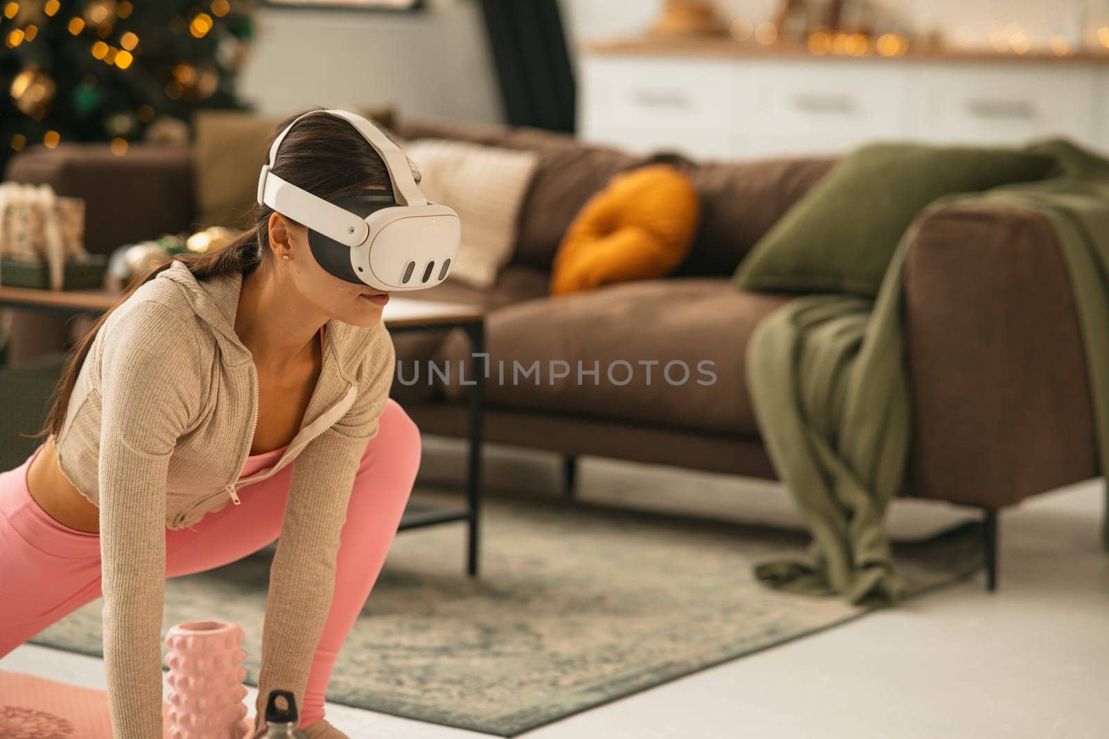 A graceful young lady in athletic attire stretching while using a virtual reality headset. High quality photo