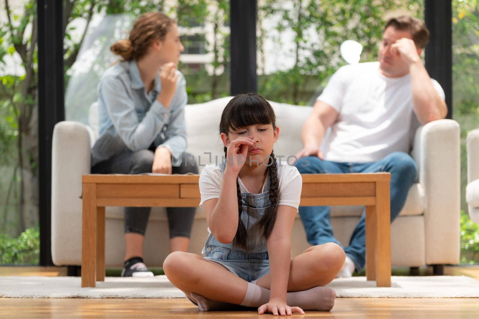 Young girl trapped in the middle of tension by her parent argument. Synchronos by biancoblue