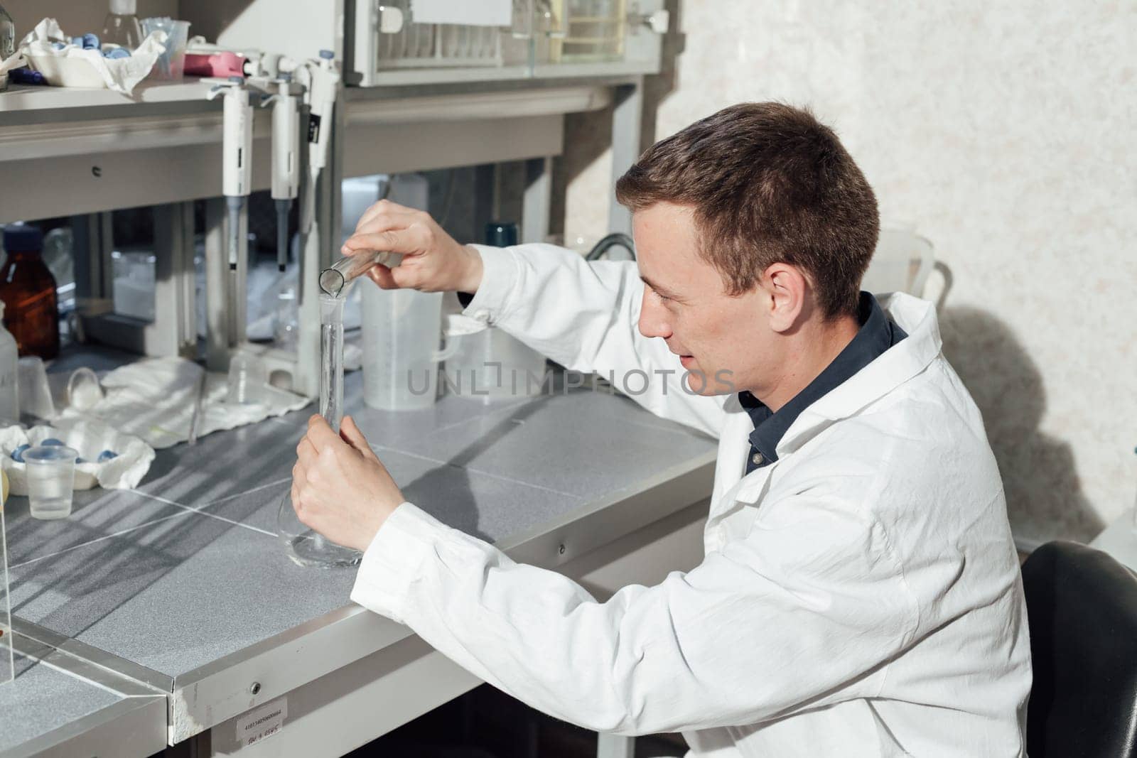 scientist conducts experiments with liquids in the medical laboratory